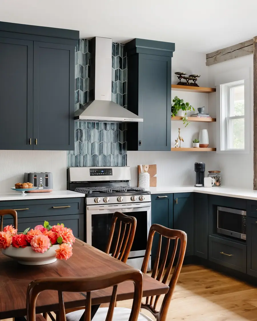 Kitchen with deep blue cabinetry, a range hood and a rustic wood post