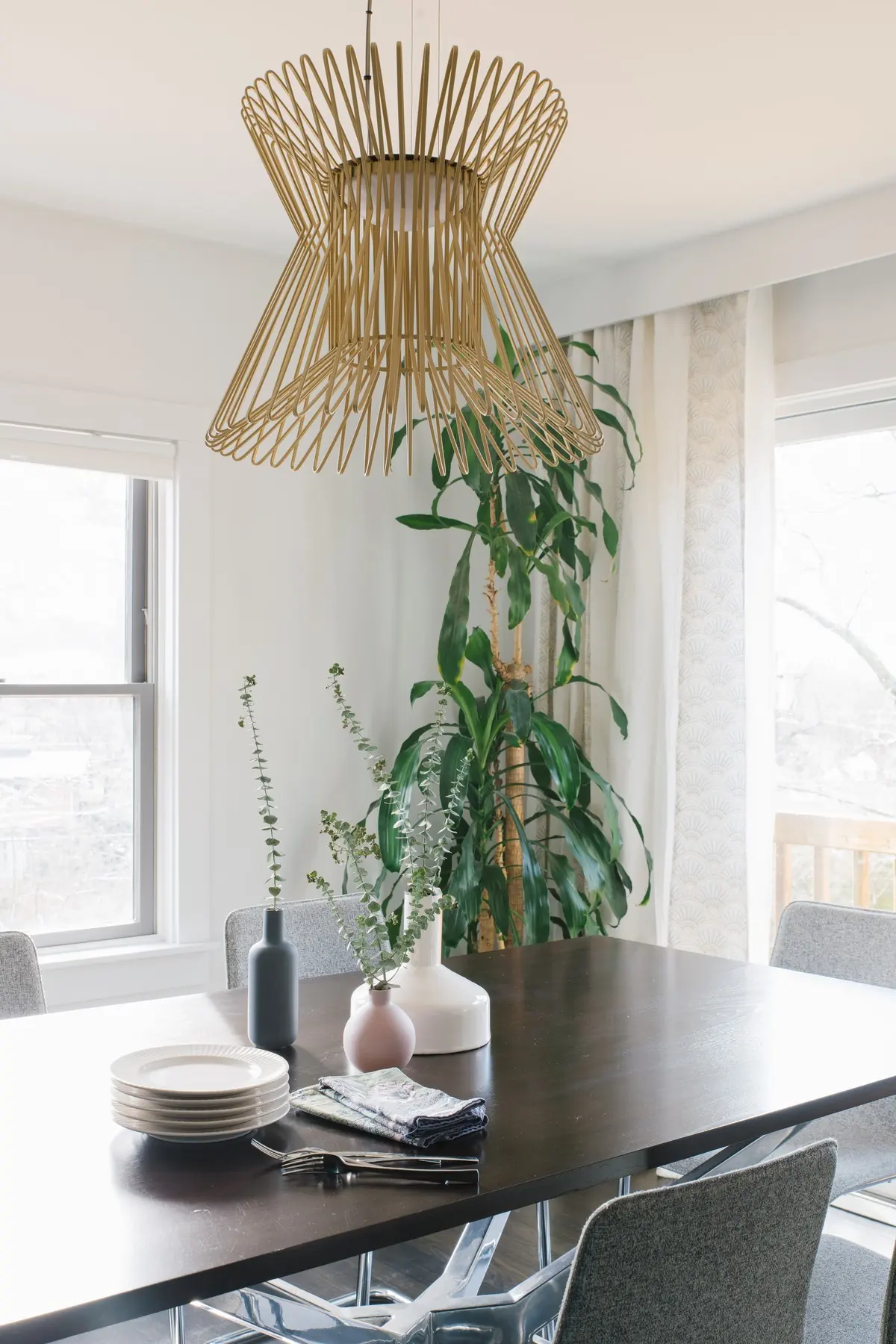 Dining table under a gold wire pendant