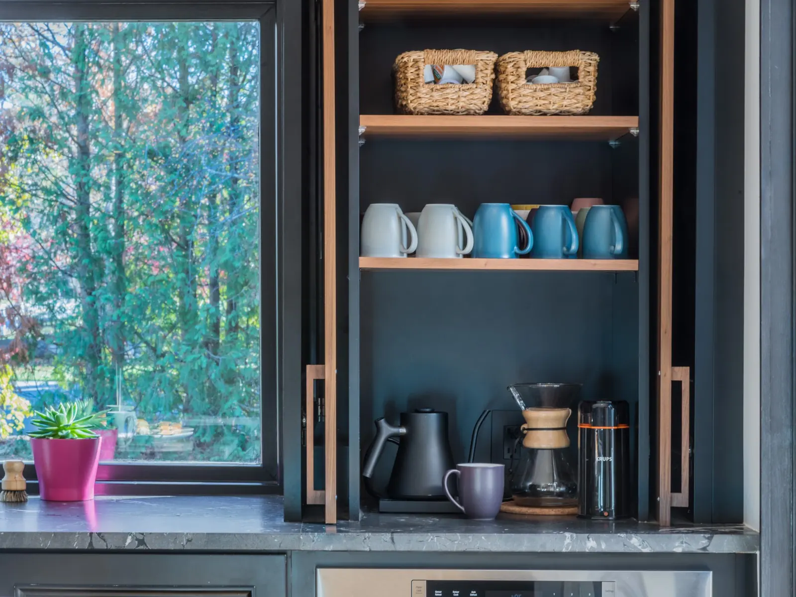 Built-in coffee station with open wood shelves and black cabinetry beside a window