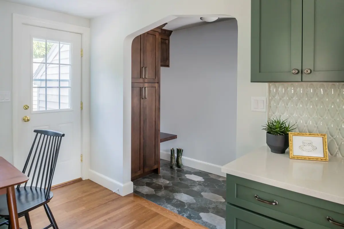 Arched opening to a mudroom with built-in wood lockers