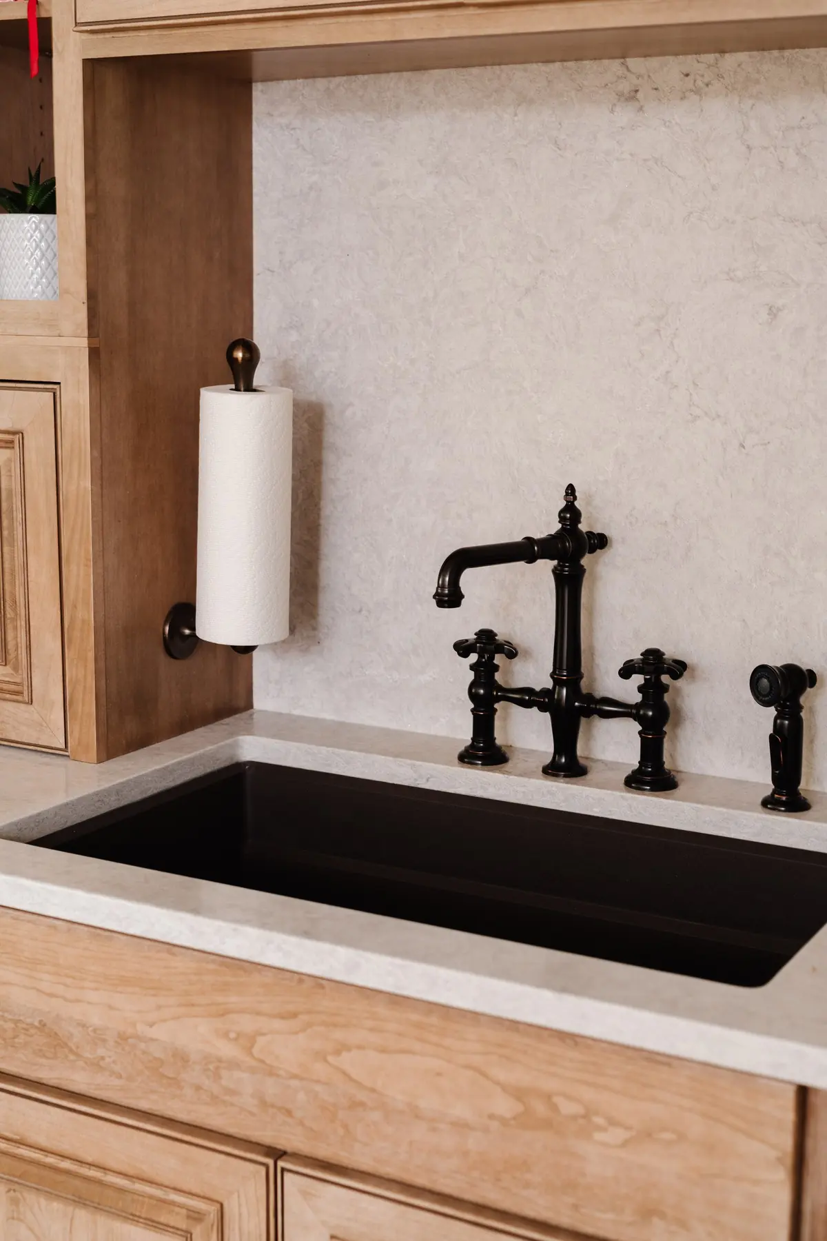 Undermount sink with a bridge faucet set in wood cabinetry